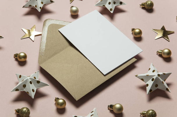 Christmas card template mock up. Blank card with envelope on pin - Fotó, kép