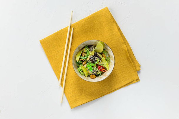 Salad from seaweed, tree mushroom, tacuan, roasted peanuts, sesame seeds, lime and chili. Asian cuisine, horizontal orientation, flat lay. - Photo, Image