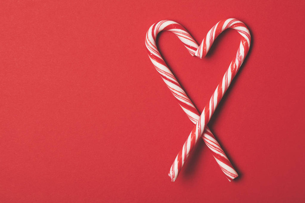 Christmas festive candy cane on a red background - Foto, Bild