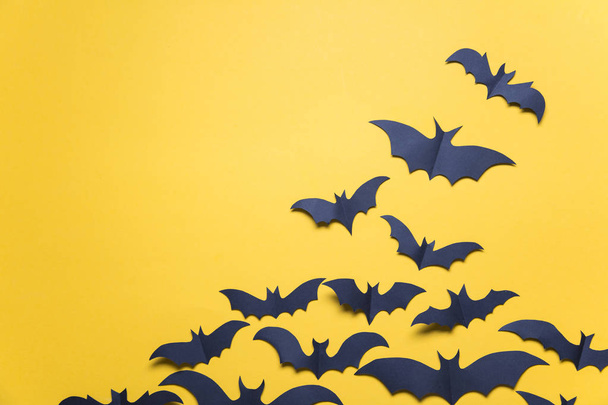 Halloween paper vampire bat decorations on an orange background. - Foto, imagen