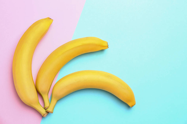 Ripe tasty bananas on color background, flat lay with space for text - Photo, Image