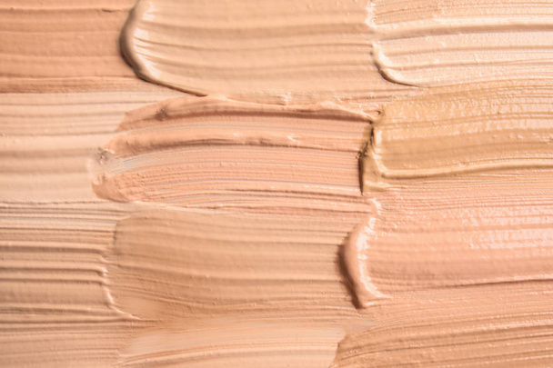 Samples of different foundation shades as background, top view - Foto, immagini