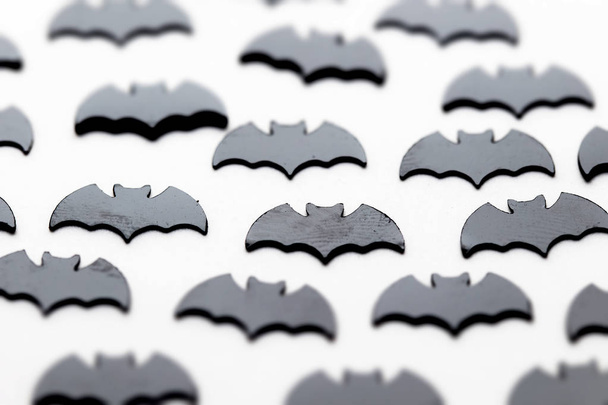 Black bat shapes on a white background. Halloween background - Foto, afbeelding