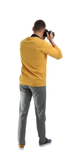 Young photographer with professional camera on white background, back view - Foto, Imagen