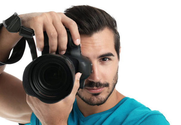 Young professional photographer taking picture on white background - Foto, immagini