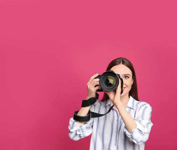 Professional photographer taking picture on pink background. Space for text - Fotografie, Obrázek