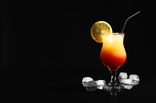 Just made appetizing cocktail Sex on the Beach, black background. Space for text - Фото, зображення