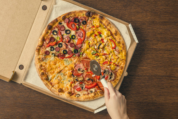 Close-up of  backed pizza  and hands on  background - Foto, immagini