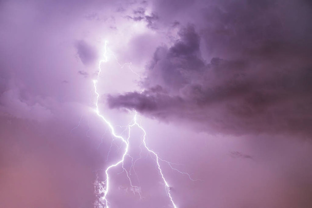 Closeup of lightning strike on the night cloudy sky. - Photo, Image
