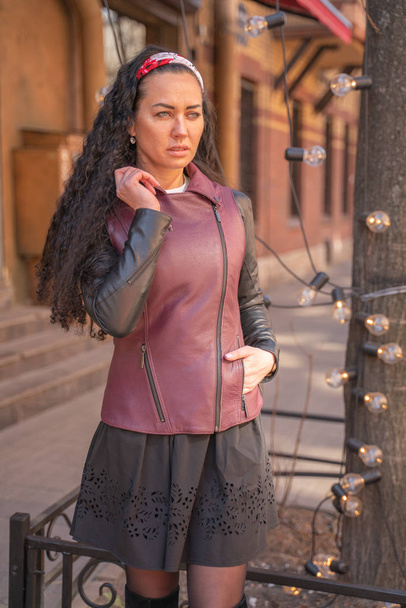 Portret van mooie jonge vrouw dragen stijlvolle leren jas - Foto, afbeelding