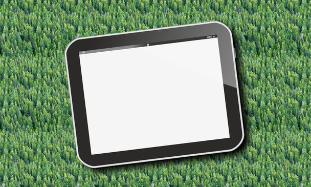 Tablet pc over green forest trees, birds eye view - Foto, Imagen