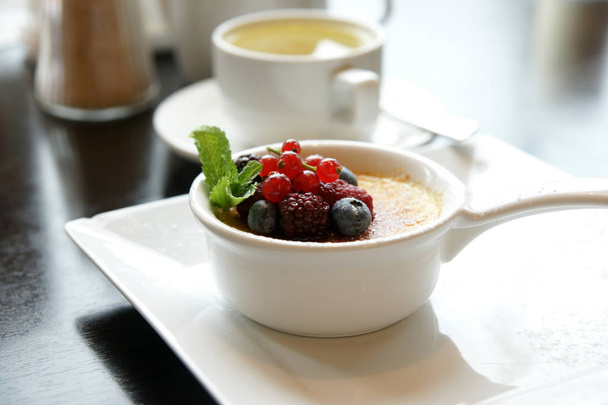 Delicious dessert creme brulee with berries - Фото, зображення