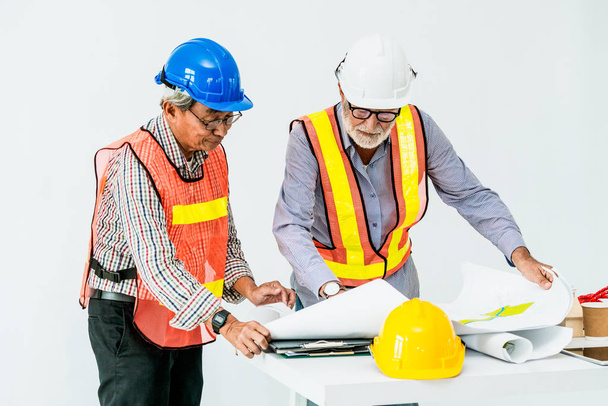 Senior engineer and architect working with drawing - Photo, Image