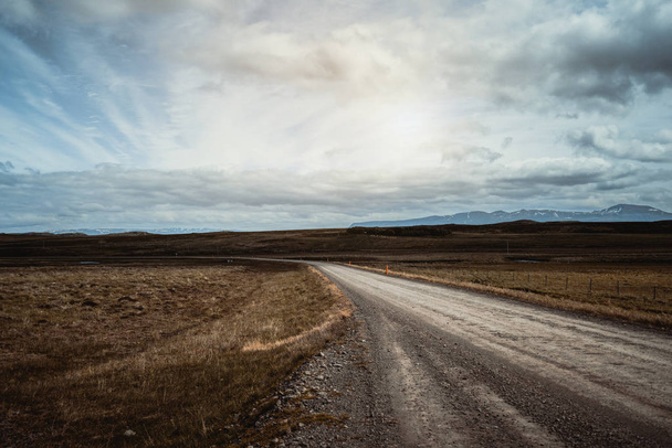 Empty dirt road through countryside landscape. - Zdjęcie, obraz