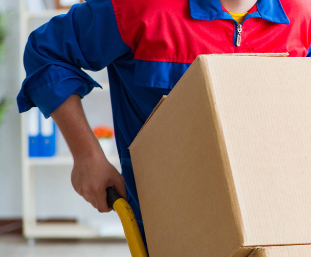 Young man working in relocation services with boxes - Photo, Image