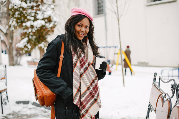 Elegant black girl in a winter city - Фото, зображення