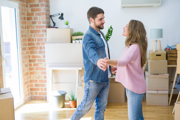 Young couple dancing celebrating moving to new apartment around  - Foto, immagini