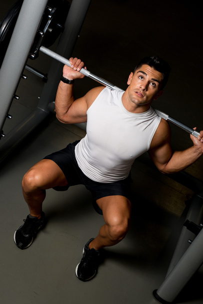 Man working out in a gym - Фото, изображение