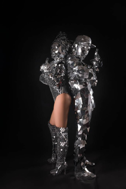 Woman and man in shine metal chain mail costume - Foto, immagini