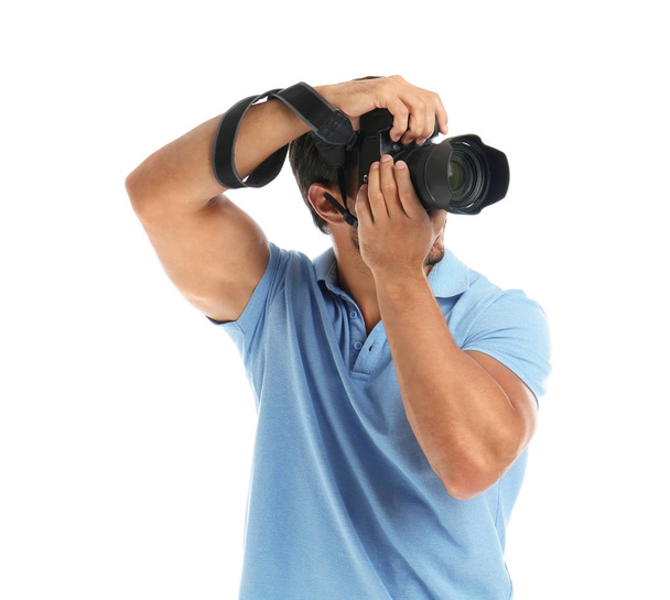 Young professional photographer taking picture on white background - Fotó, kép
