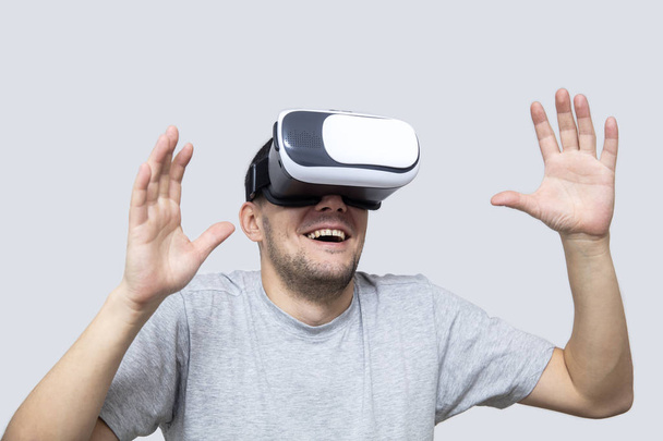 Young man using vr headset in studio, experiencing virtual reality - Φωτογραφία, εικόνα