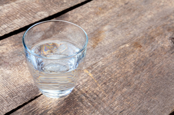 Glass of water on a wooden table - Фото, изображение