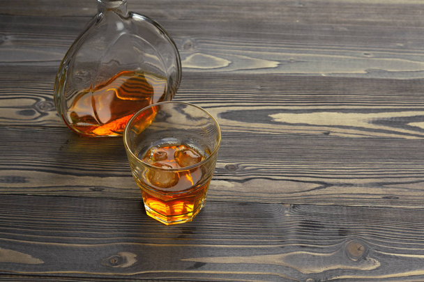 whiskey with ice cubes on wooden background - Fotoğraf, Görsel