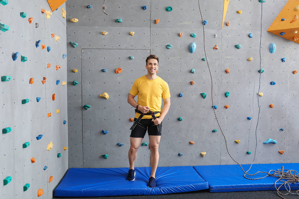 Sporty young man in climbing gym - Photo, Image