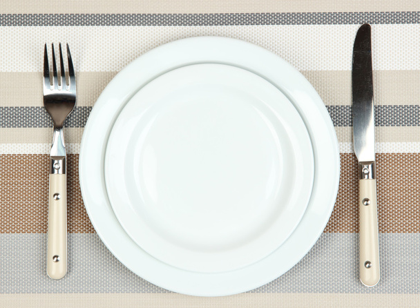 Knife, color plate and fork, on color background - Foto, afbeelding