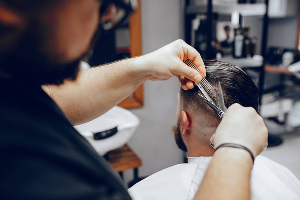 Stylish man sitting in a barbershop - Фото, зображення