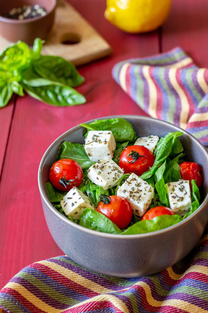 Salad with tomatoes, spinach and cheese. Italian cuisine. Healthy eating. Diet. - Fotó, kép