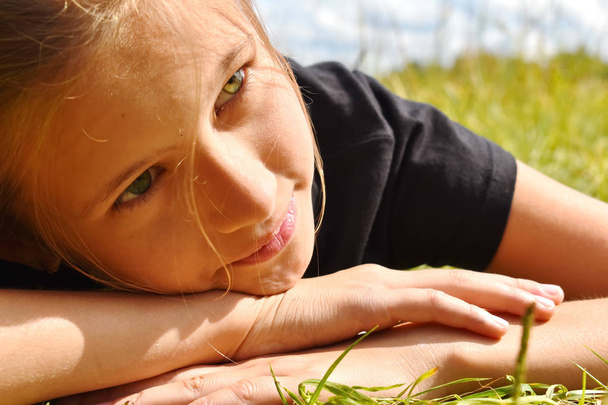 Szép kislány egy zöld fű nyáron. - Fotó, kép