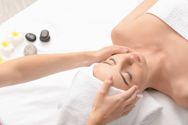 Young woman having facial massage in beauty salon - Фото, зображення