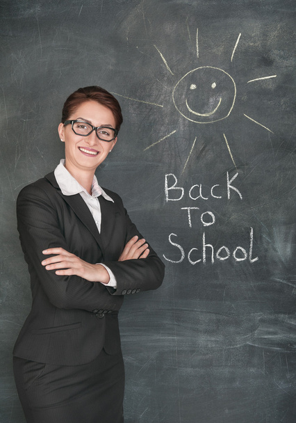 Happy teacher and smiling sun on the chalkboard - Photo, Image