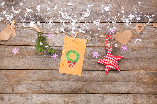 Χειροποίητη Χριστουγεννιάτικη κάρτα με διακόσμηση σε ξύλινο φόντο - Φωτογραφία, εικόνα