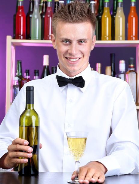 Bartender is pouring white wine into glass - Φωτογραφία, εικόνα