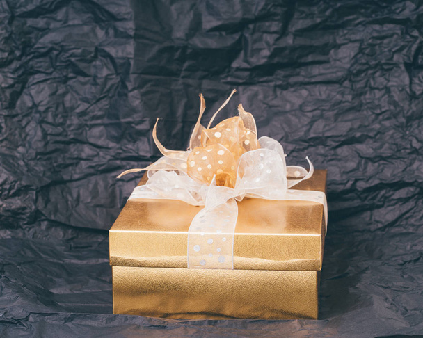 Gold gift box on black background - Foto, Imagem