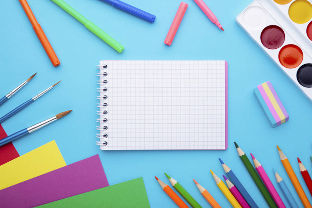 Back to school concept on blue background with copy space - Фото, изображение