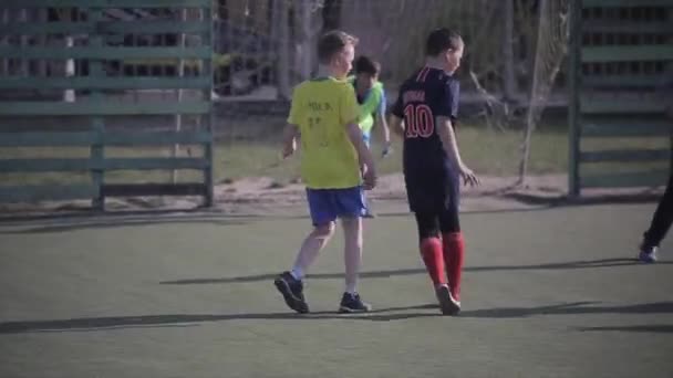 Minsk, Belarus - 11 January 2019: Young boys playing football soccer game on sports field - Felvétel, videó