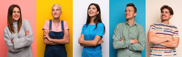 Set of people over colorful backgrounds looking up while smiling - Photo, Image