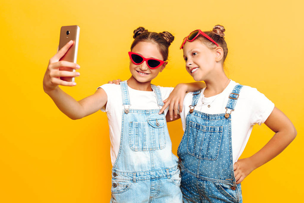 Two teenage girls, girlfriends have a rest and take a selfie on  - Zdjęcie, obraz
