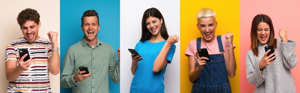 Set of people over colorful backgrounds with phone in victory position - Фото, зображення
