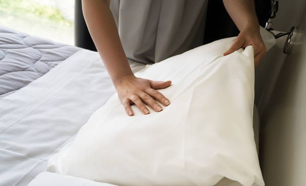 Room service. Woman making bed in hotel room. - Zdjęcie, obraz