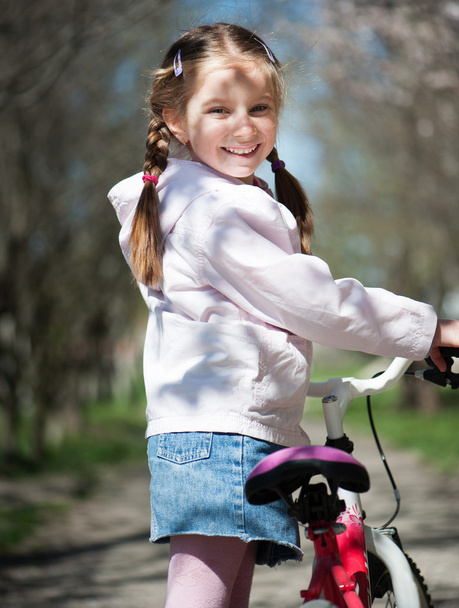 little girl on her bike - Фото, изображение