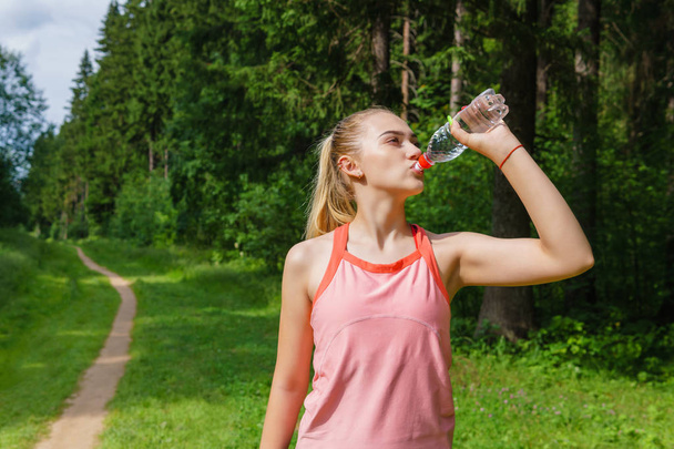 female jogger quenches thirst - Photo, Image