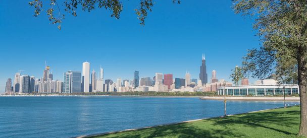 Panoramic Chicago downtown buildings and mature trees in foreground along Michigan Lake - Photo, image