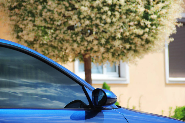 Part of a blue car. Car on a background of tree - Fotó, kép