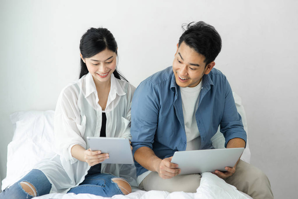 Surprising Asian couple using laptop at home, lifestyle concept. - Foto, Bild