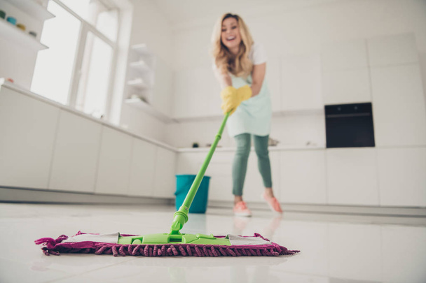Full length body size view portrait of her she nice attractive cheerful cheery wavy-haired lady enjoying making professional cleanup easy fast service in light white interior kitchen - 写真・画像