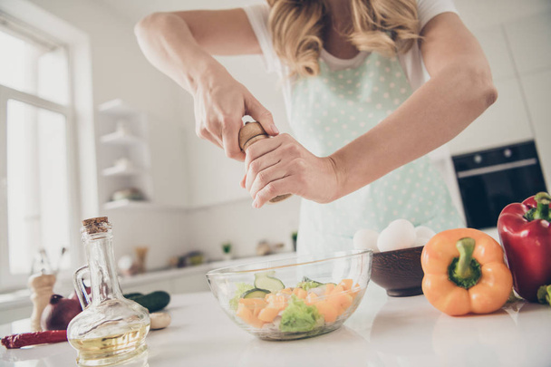 Cropped view of wavy-haired lady making fresh homemade domestic vitamin complex tasty yummy delicious dinner lunch in light white interior kitchen indoors - Photo, Image